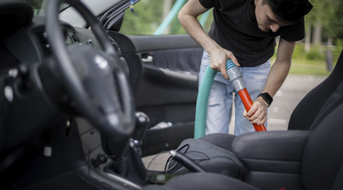 vacuuming a car