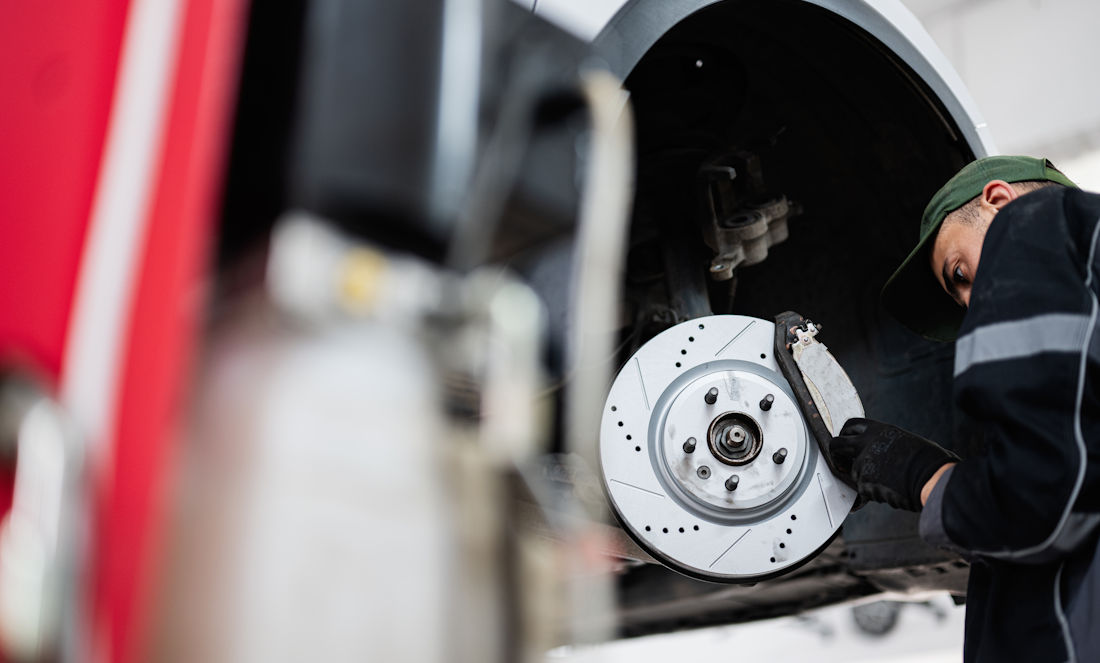 mechanic checking brakes