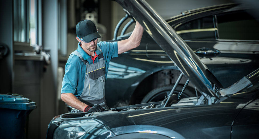 mechanic looking under the hood