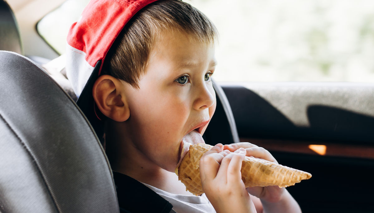 kid eating ice cream in the car
