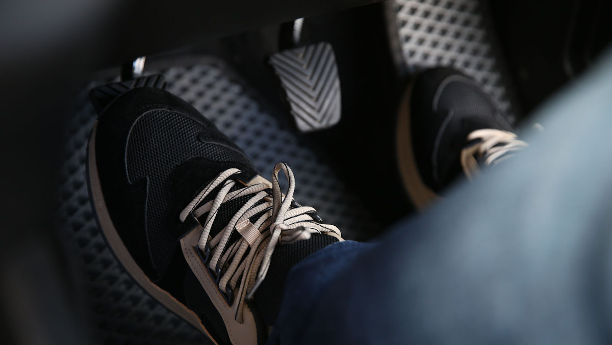 feet on pedals in car